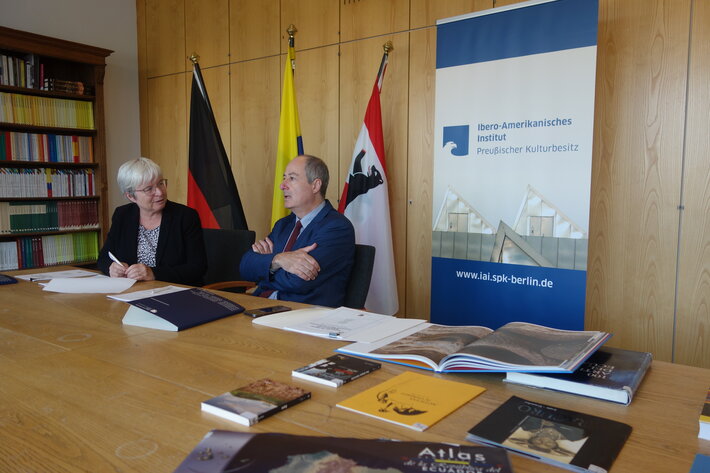 Zwei Personen unterhalten sich an einem Tisch sitzend