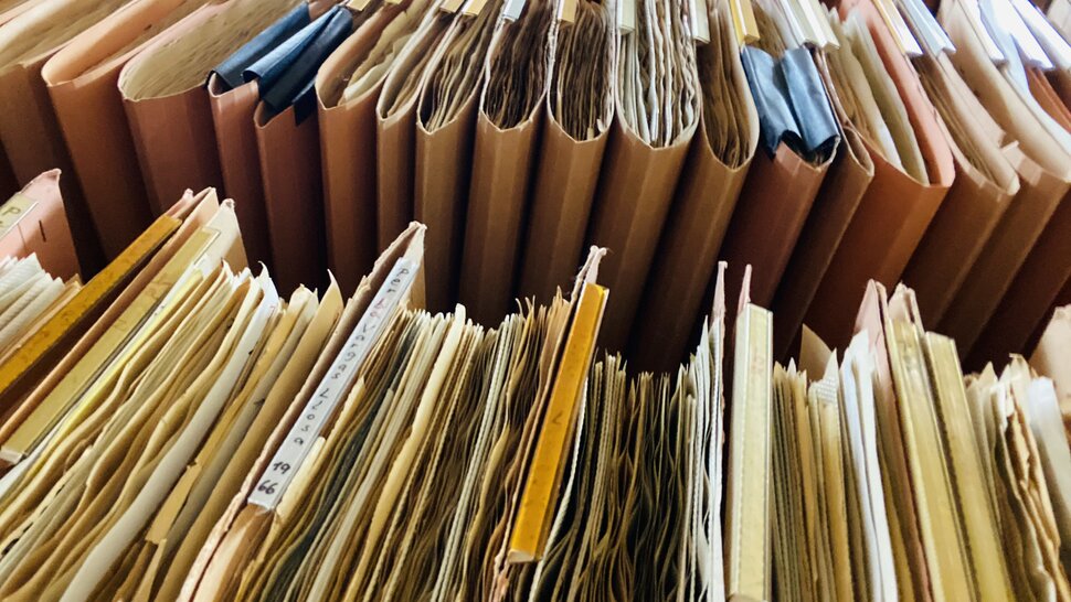 Arquivo suspenso com recortes de jornais