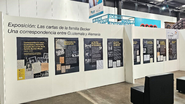 Ausstellungstafeln an einer großen Stellwand in einer Messehalle